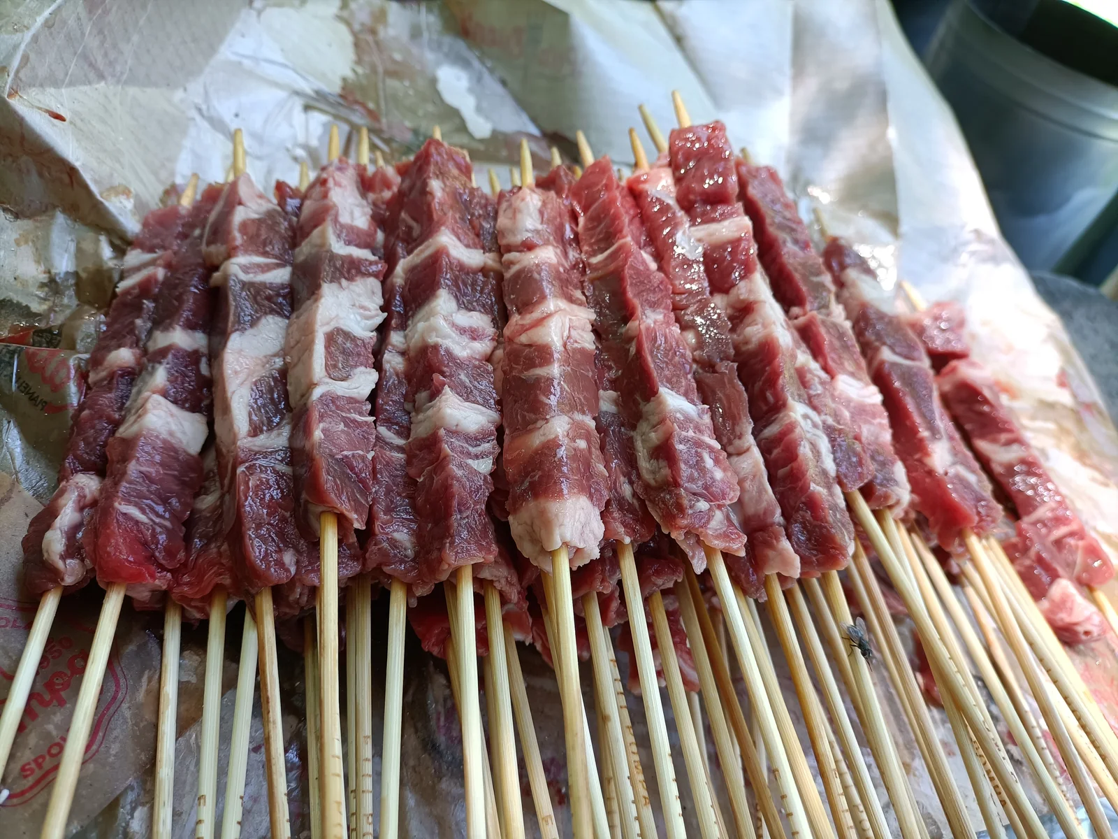 Uncooked arrosticini skewers prepared for grilling
